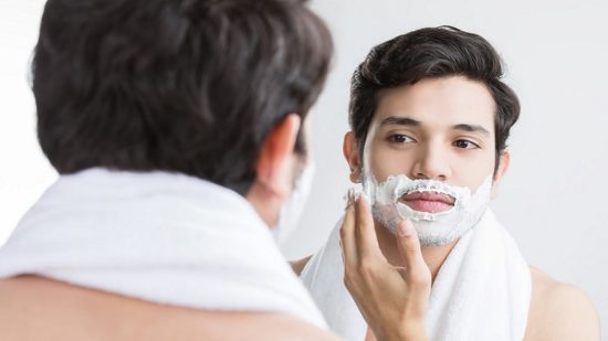 Man shaving in the bathroom.